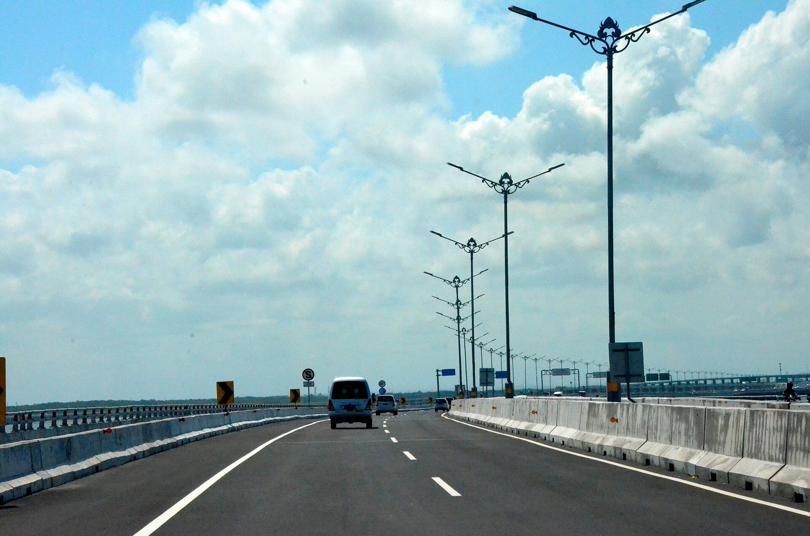 Bali Mandara toll road crossing the water toward Nusa Dua under a blue sky
