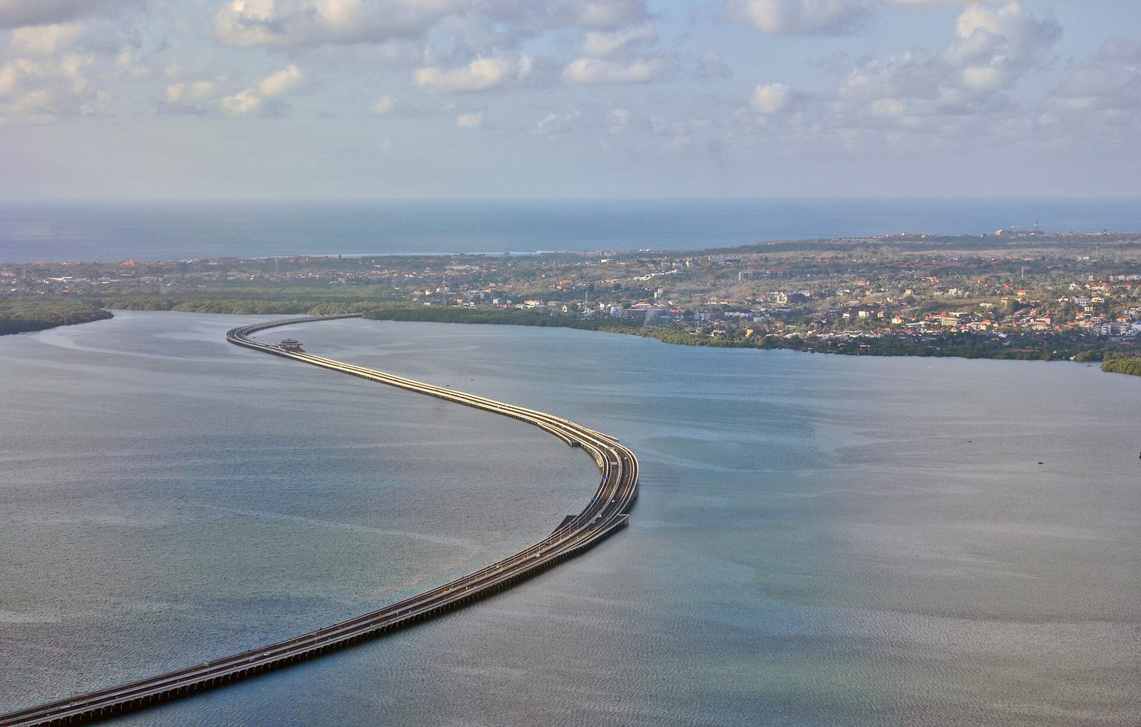 Aerial view of the Bali Mandara toll road curving across Benoa Bay
