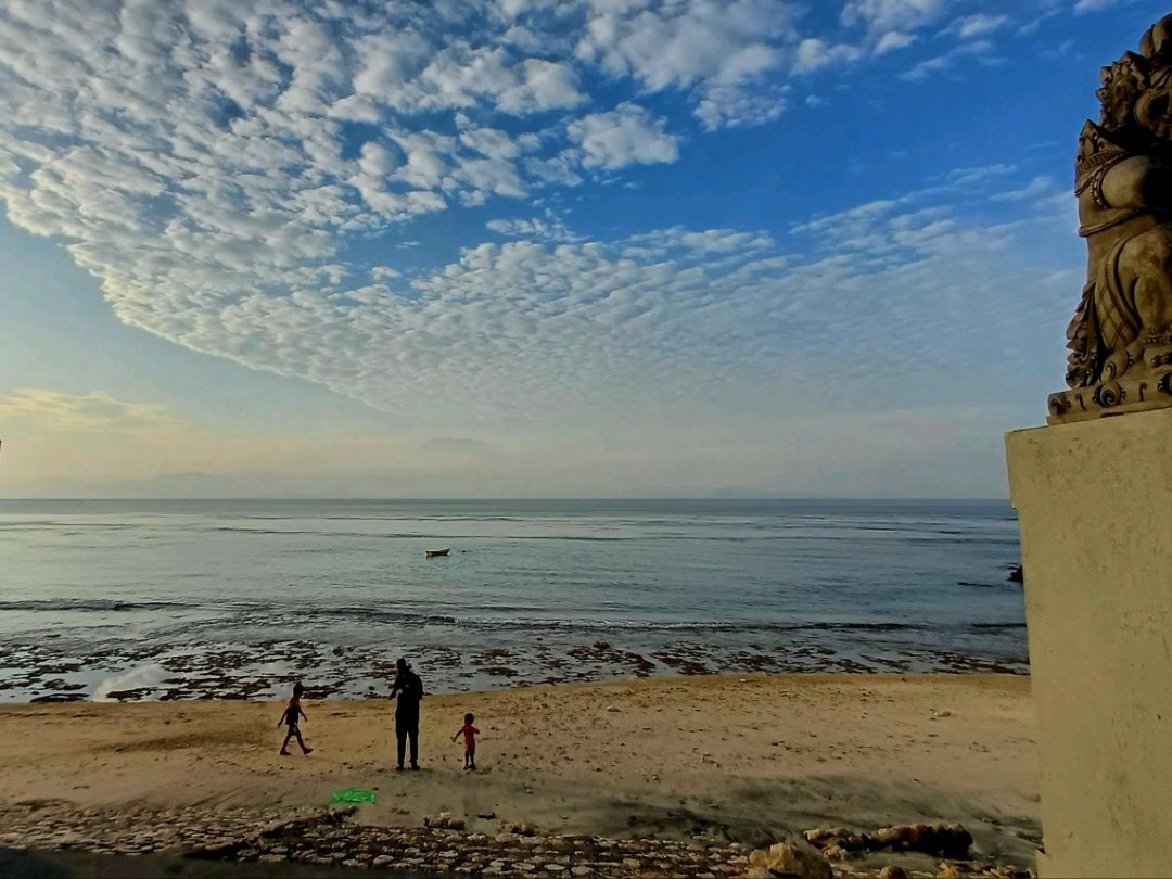 Visitors on a small stretch of sand at Kutampi
