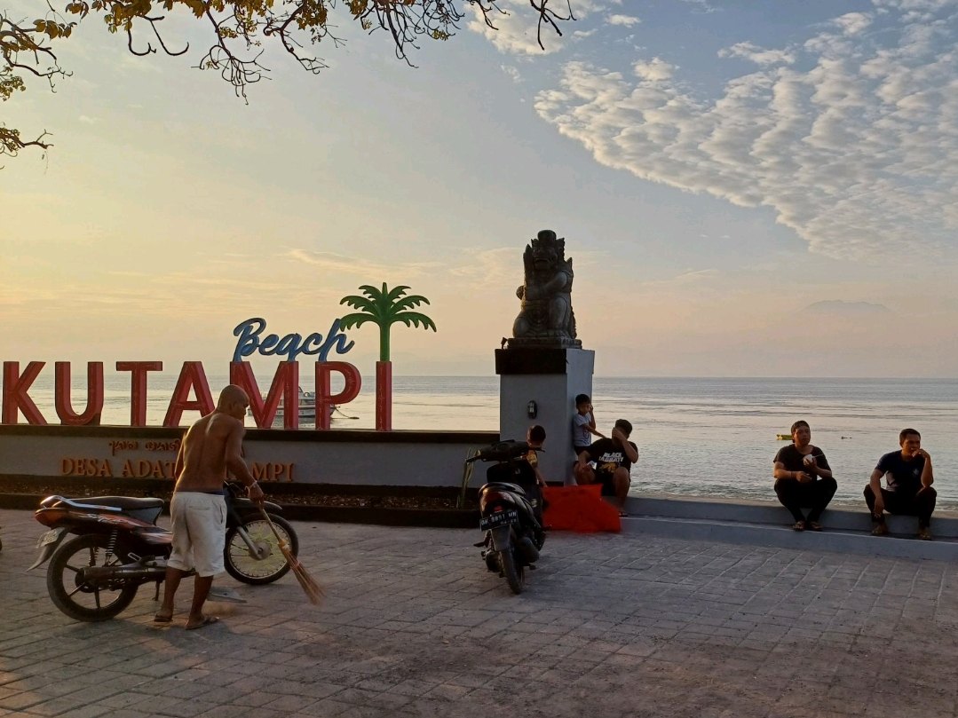 Kutampi beach sign and temple structure beside the shore