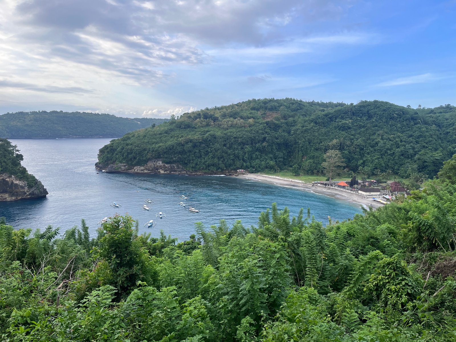 Crystal Bay beach and boats seen from the hillside path toward Pandan Beach.