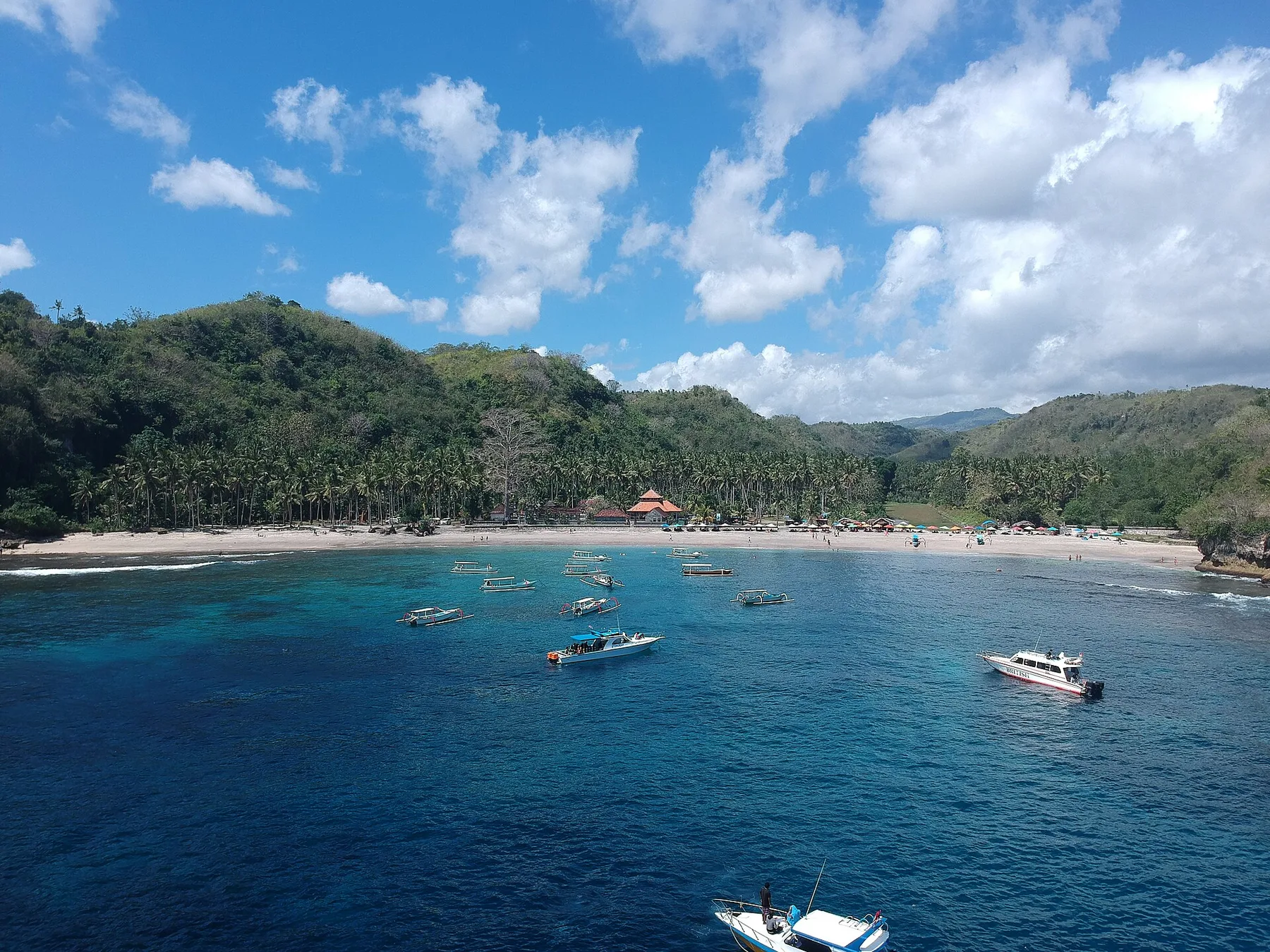 Crystal Bay beach, boats, and offshore island in Nusa Penida