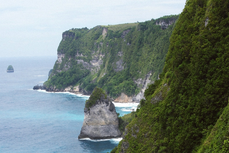 Steep green limestone cliffs on the coast of Nusa Penida
