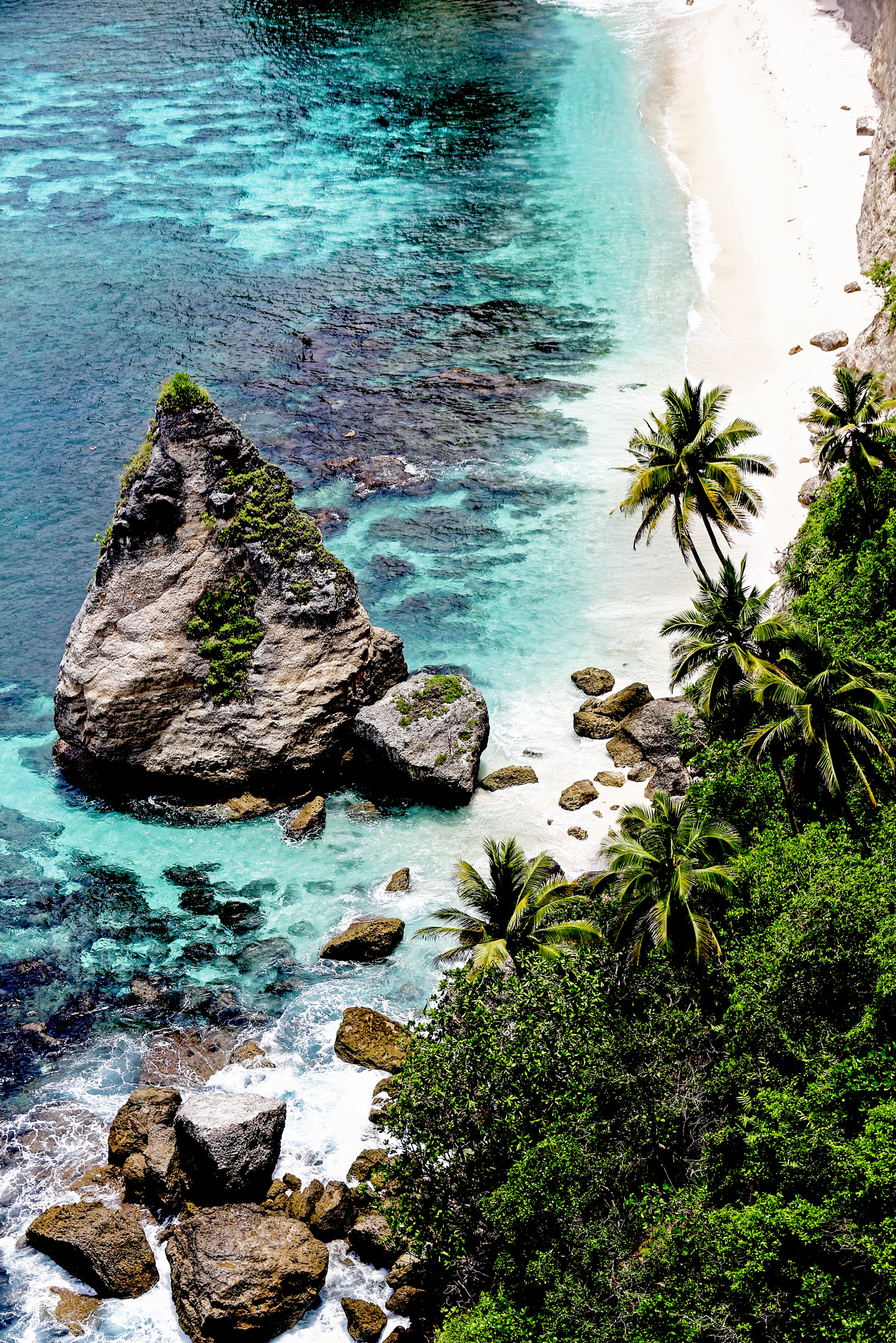 Tropical beach beneath limestone cliffs in Nusa Penida