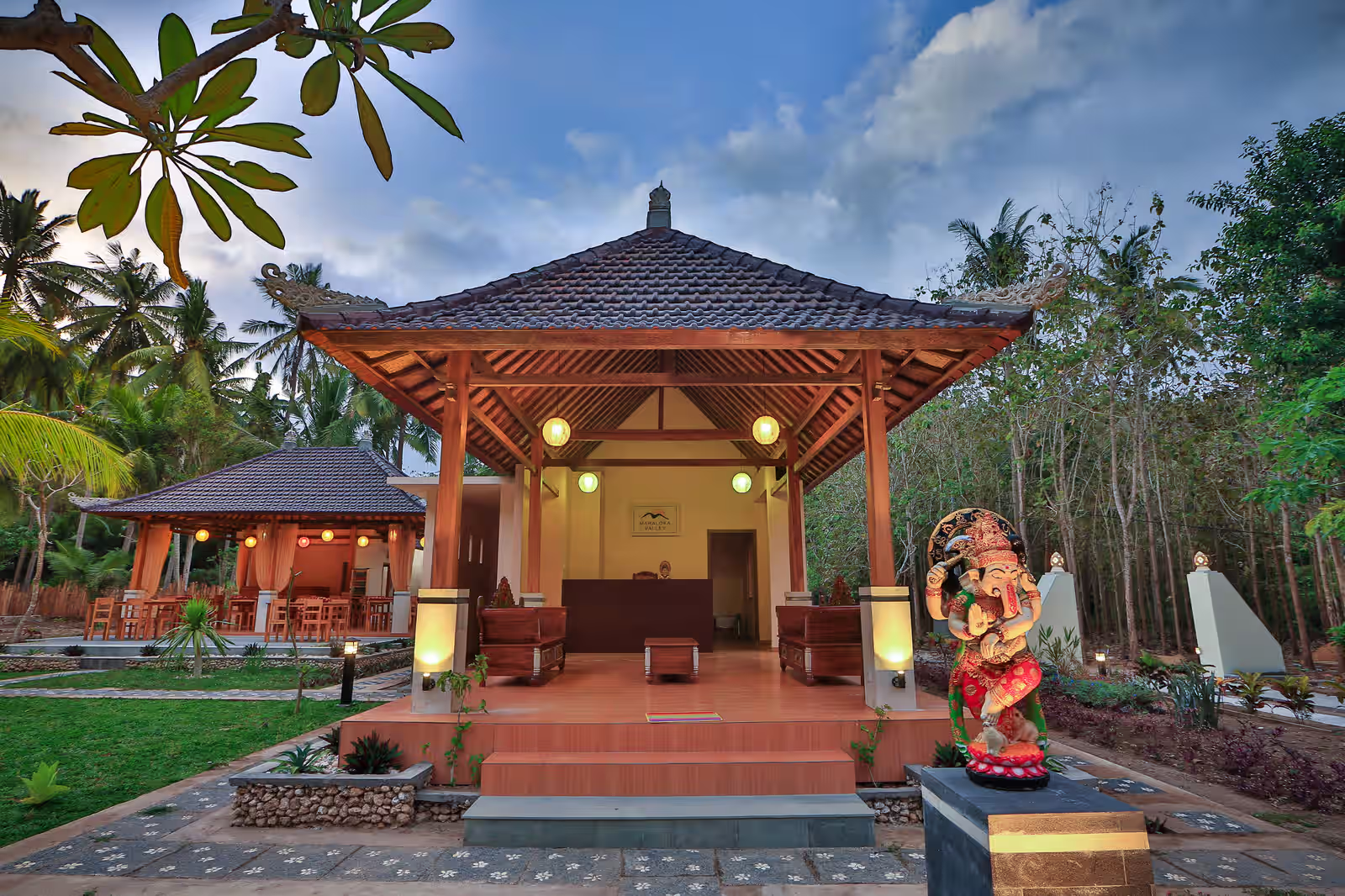 Open-air reception pavilion and garden at Mahaloka Valley at dusk