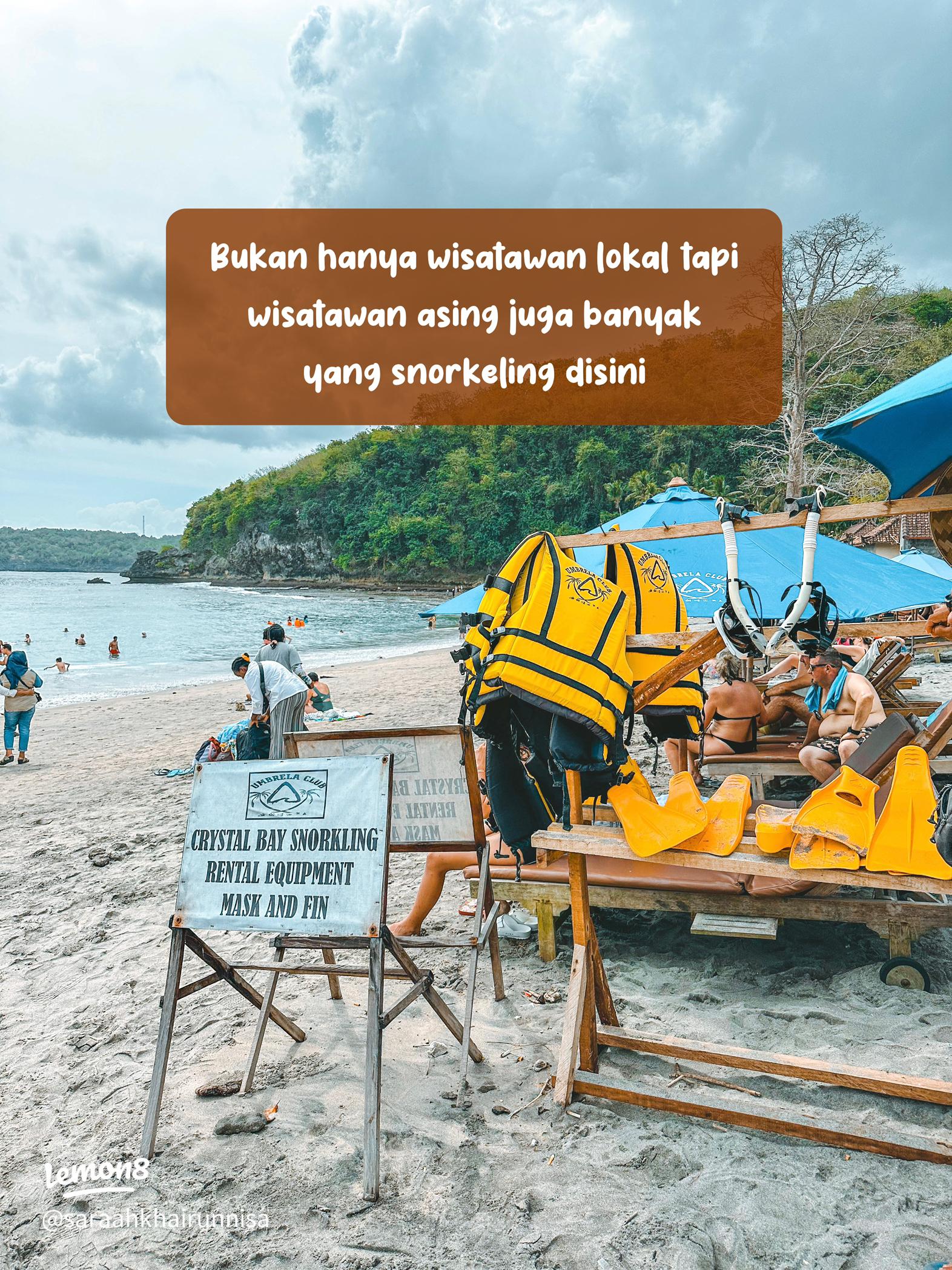 Snorkeling masks, fins, life jackets, and a rental sign on Crystal Bay beach