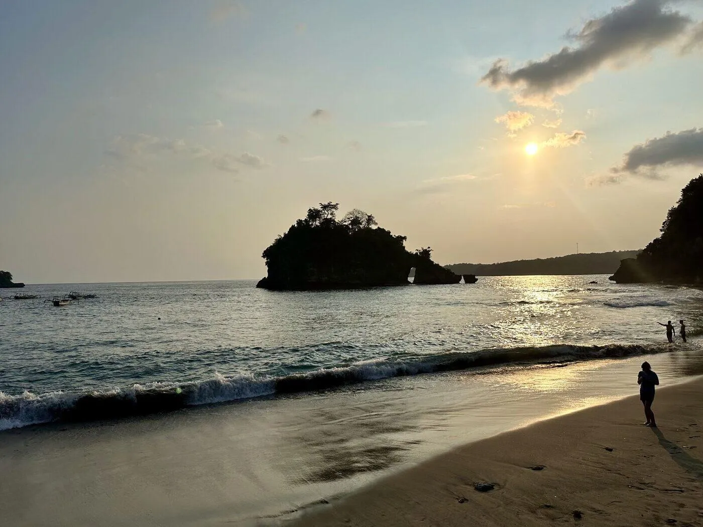 Sunset over the rock island and warm water at Crystal Bay in Nusa Penida