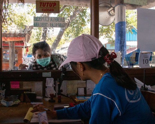 Gangga Express staff serving a passenger at the official ticket counter