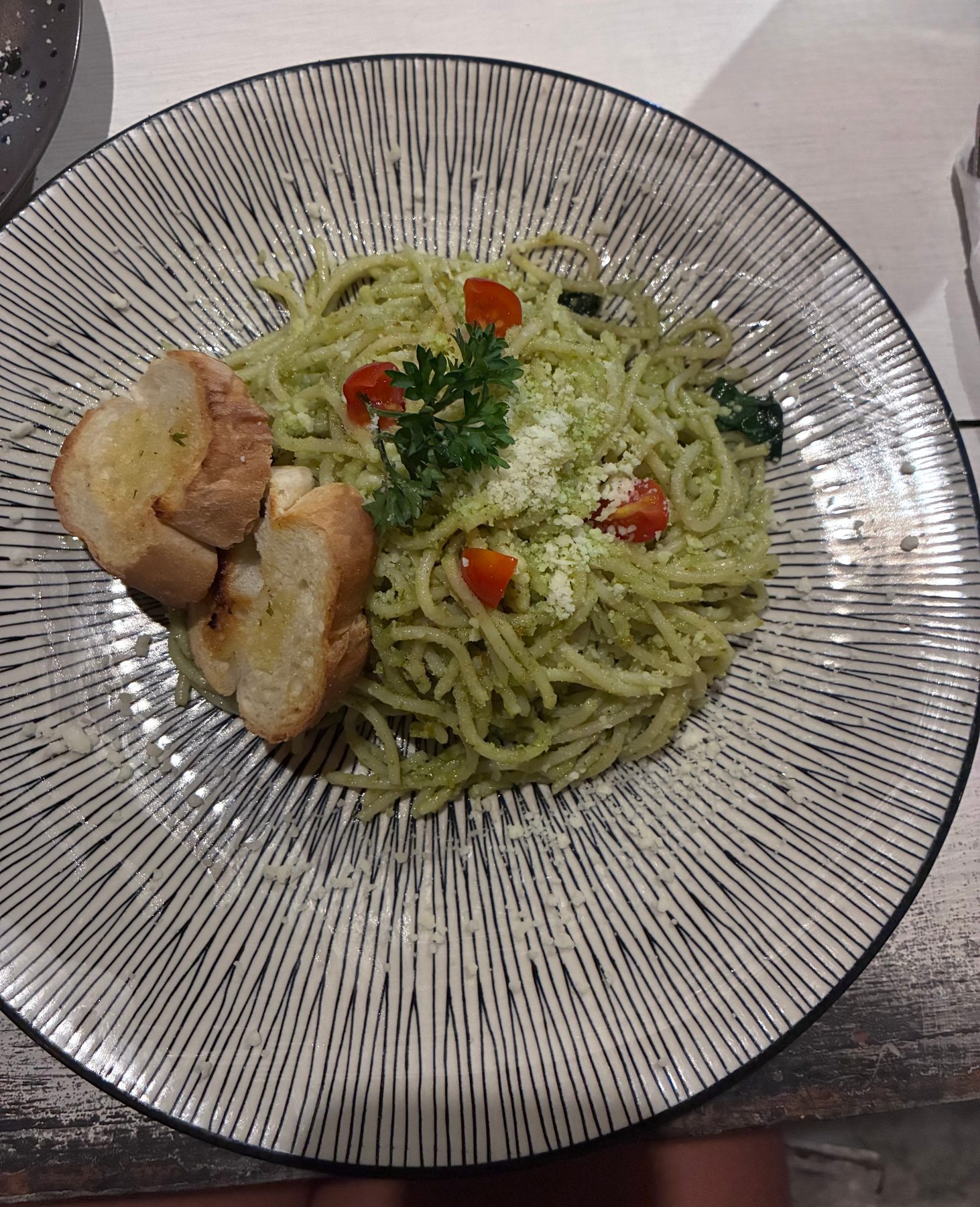 Pesto spaghetti with cherry tomatoes, parmesan and toasted bread at Holy Penida